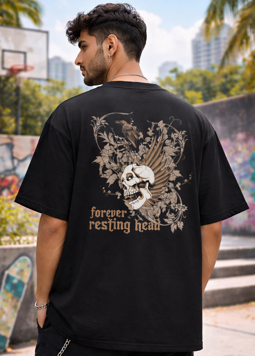 Person wearing a black t-shirt with a skull design and text in an urban setting